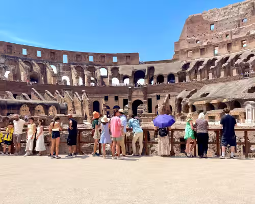 Visitors on the Colosseum Arena Floor looking down into the Underground 